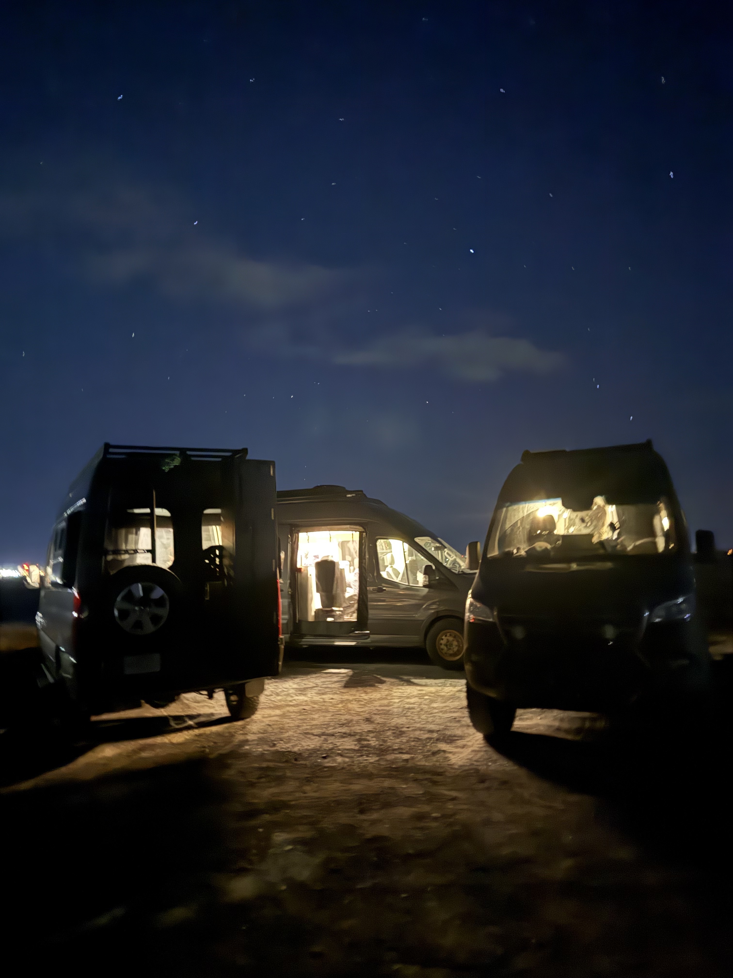 Vanlife community gathering under starry night sky