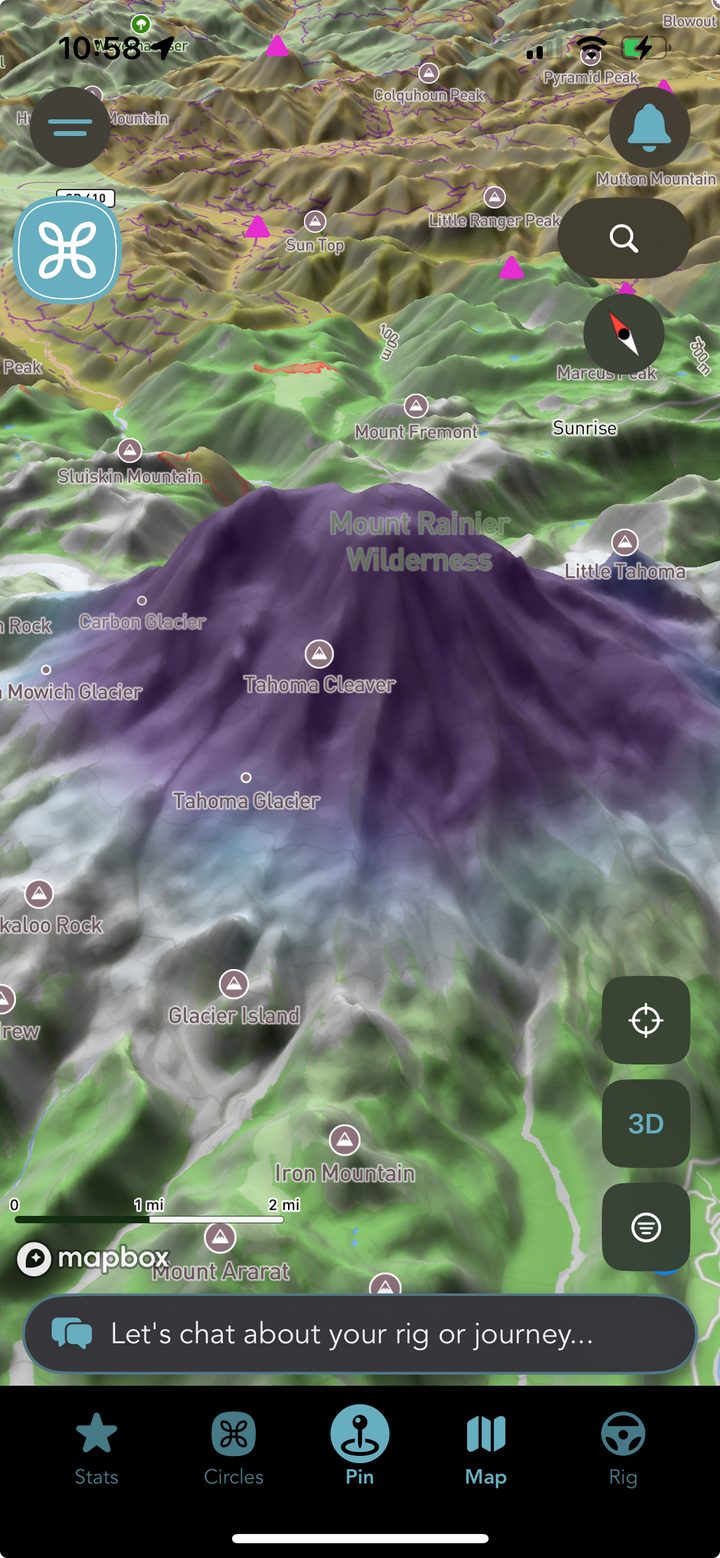 The Grover map tilted into 3D over Mount Rainier, with the snow depth layer painting the summit and upper glaciers in deep purple fading to pale blue down the Tahoma and Carbon Glaciers, surrounded by green forest, with the Stats, Circles, Pin, Map and Rig tab bar across the bottom